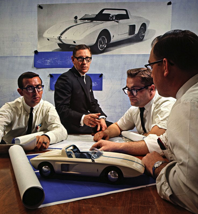 Roy Lunn in center with Ford assistants looking over the Mustang I prototype scale model Ford Motor Company Archives