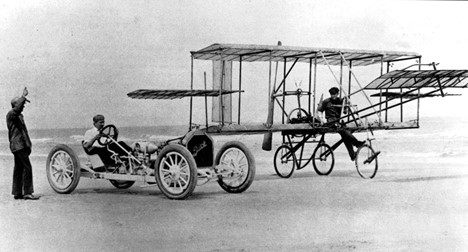 A race car and an airplane on the beach 4