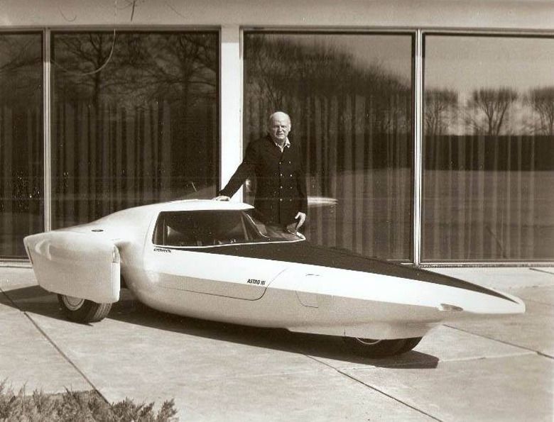Bill Mitchell standing next to the Astro III concept car